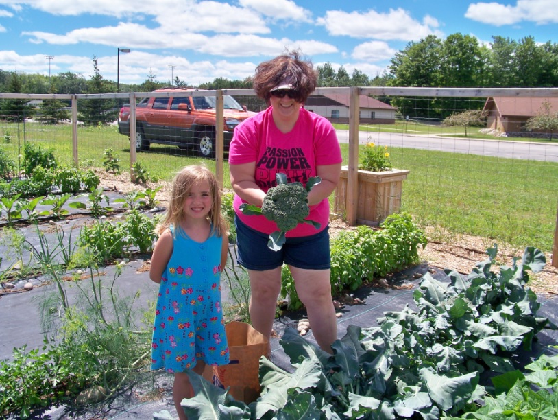 Lead teacher Valorie Haneckow and Alcona Community Elementary student Makayla harvested the first crop of broccoli for the summer of 2013.