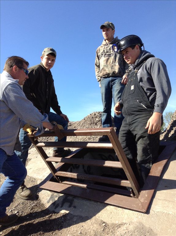 AHS industrial arts students installing the gate on the north hibernaculum.
