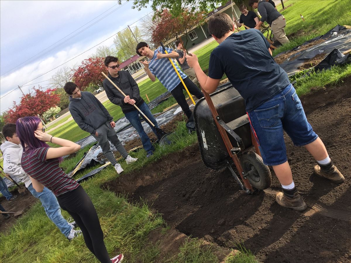 Students moving soil into the rain garden