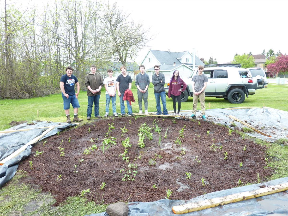Students stand with newly installed rain garden