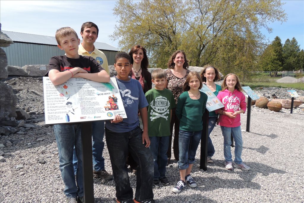 Students showcasing the custom signs they designed