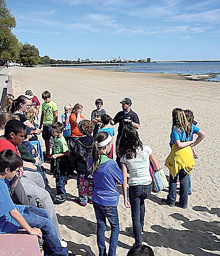 Thunder Bay Junior High sixth-graders learn about the biology of the beaches of Thunder Bay from Michigan Sea Grant extension educator Brandon Schroeder at Mich-e-ke-wis Park on Wednesday.