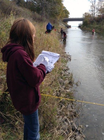 girl_collecting_data_at_river.jpg